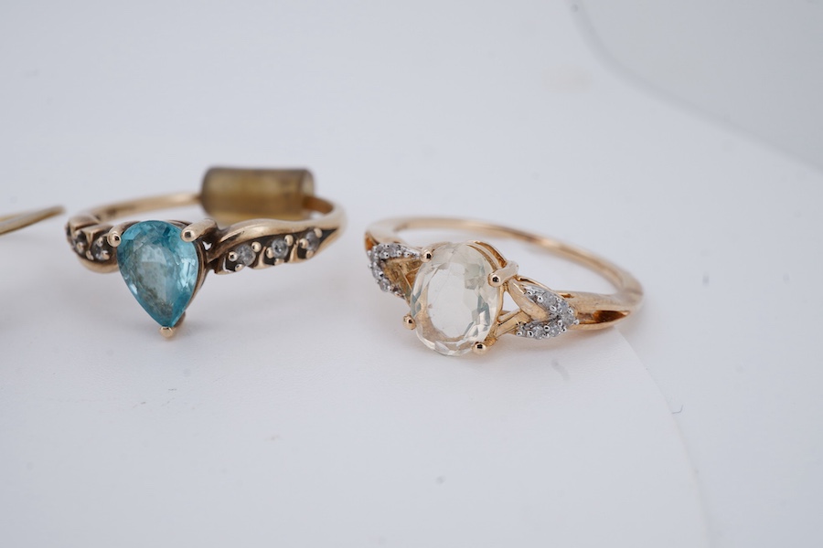 Seven gem-set rings, comprising: a faceted opal and diamond ring; a kunzite and colourless paste cluster ring; a garnet cluster ring; a blue zircon and colourless paste ring; and a tanzanite ring, all mounted in 9ct gold